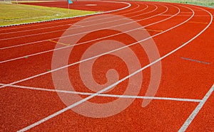 Red Running track with corner of the football field.