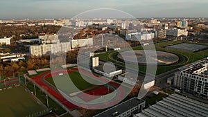 Red Running Track sports field in Urban City Area with futuristic Velodrome Building cycling Arena in Berlin, Germany