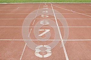 Red running track in stadium at starting point