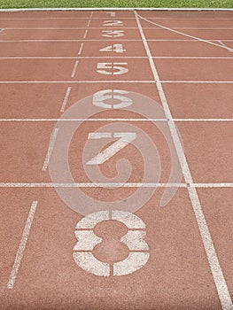 Red running track in stadium at starting point