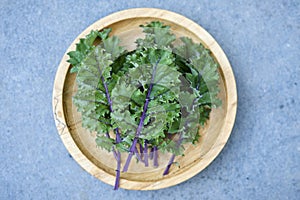 Red Russian Kale on Wooden Plate Overhead View