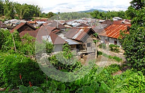 Red rusted iron roofs and a satellite in an authentic Indonesian village