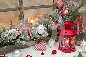 Red rustic christmas decoration on window sill with red checked photo