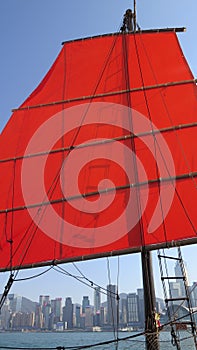 Red sail of the AquaLuna touring junk