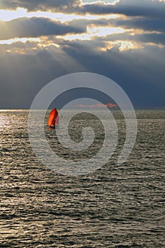 Red sail at sunset in sea
