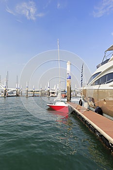 Red sailboat moored in the marina