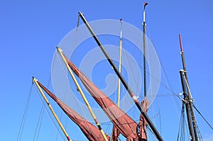 Red sails furled on jibs