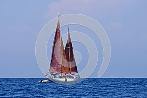 Red sails. Staysail schooner.
