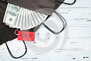 Red sale tag, dollar banknotes
