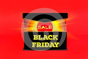 Red sale tag with glowing light in black box