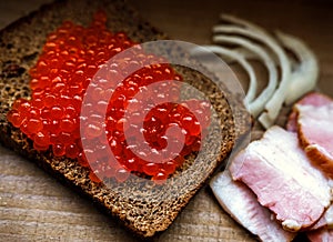 Red salmon caviar on a slice of rye bread