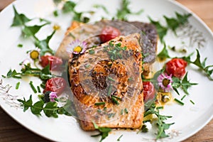 Red salmon trout with tomato and leaf.