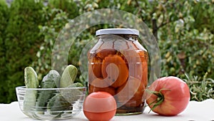Red salted tomatoes in a glass jar