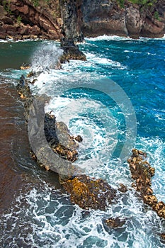 Red Sand Beach, Maui in in Hawaiian. Ocean waves and rock.