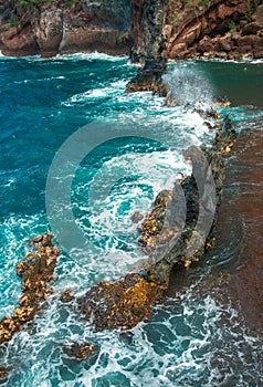 Red Sand Beach, Maui in in Hawaiian. Ocean waves and rock.