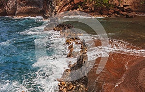 Red Sand Beach, Maui in in Hawaiian. Sea Wave and rock, summer beach background.