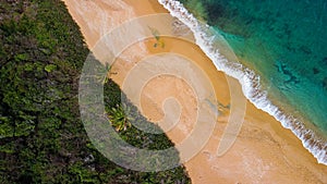 Red sand beach on tropical island from above