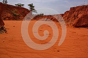 Red sand of a desert in Vietnam, footprints in the sand.