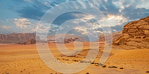 Red sands mountains, dramatic sky and marthian landscape panorama of Wadi Rum desert, Jordan