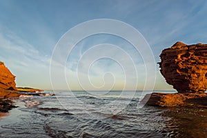 Red sandstone rocks at high tide