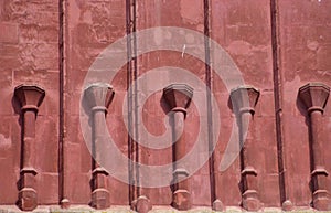 Red sanstone wall with pillars