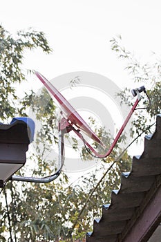 A red satellite dish on the roof