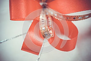 Red satin gift bow. Ribbon. Macro close up