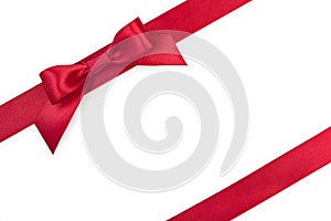 Red satin gift ribbon bow with another ribbon isolated on white background, top view