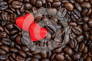 Red satin hearts on coffee beans, valentines or mothers day background, love celebrating
