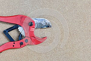 Red scissors for cutting plastic pipe