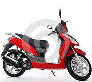 Red scooter stands on a white background