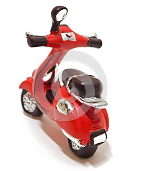 Red scooter toy isolated on white.