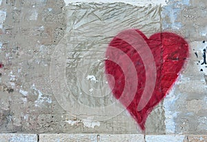 Red scratched heart on a wall