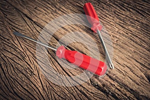 Red screwdriver on wooden background