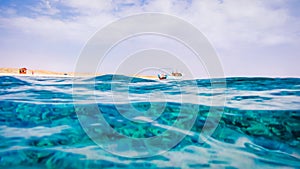 Red Sea Surface in Marsa Alam, Fisher Boat and Desert in background