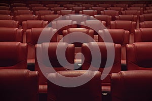 red seats in empty theatre auditorium or movie cinema