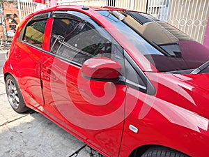 a red sedan parked in the office yard