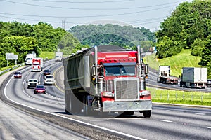 Red Semi Climbs Hill on Interstate