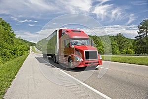 Red Semi Truck On Interstate In Springtime