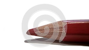 Red sharp pencil tip close-up. isolated on white background photo