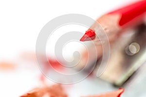 Red sharpened pencil close up macro shot on sharpener