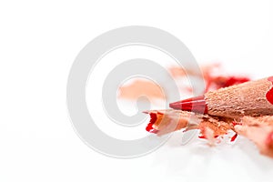 Red sharpened pencil close up macro shot on shavings