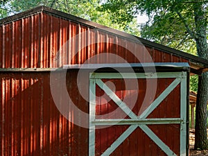 Red shed on farm with sliding door with white trim