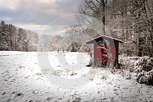 Red shed stands out in white snow scene in Pisgah Forest