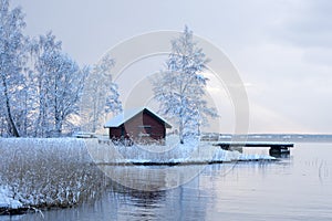 Red shed in white wintry landscape