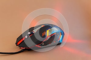 Red shine gaming mouse on brown background