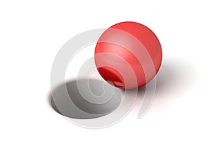 Red shiny ball in front of hole on white