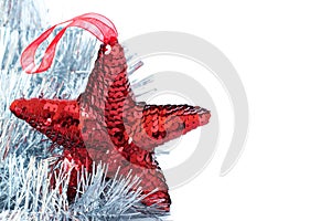 Red shiny star decoration with silver tinsel