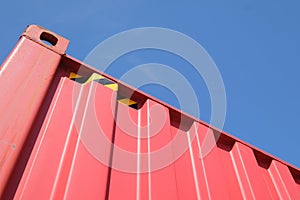 Red shipping container against blue sky