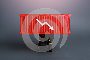 Red shipping container with down arrow. Decrease in imports and exports of goods. Trade traffic decreasing. Production fall. photo